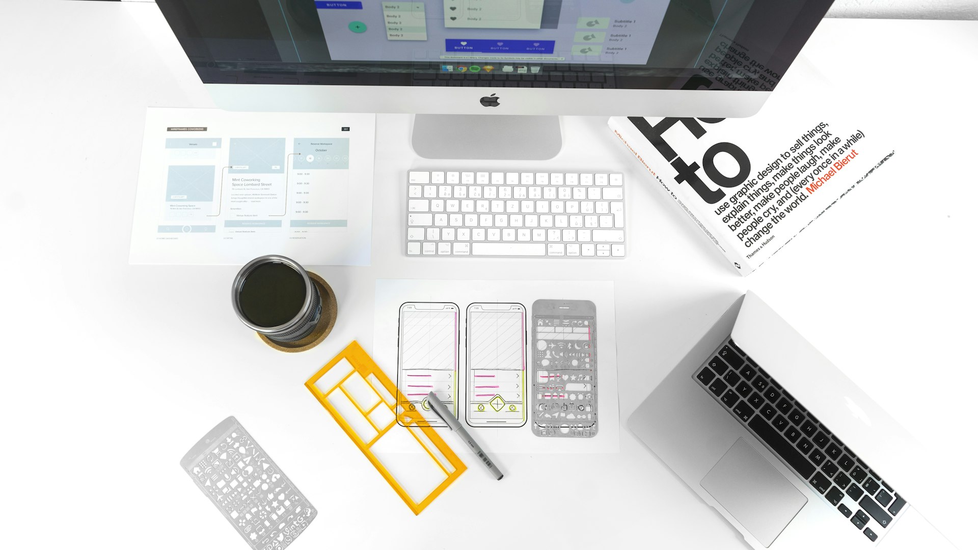 Designer's desk with branding stationery and phone mockups in progress