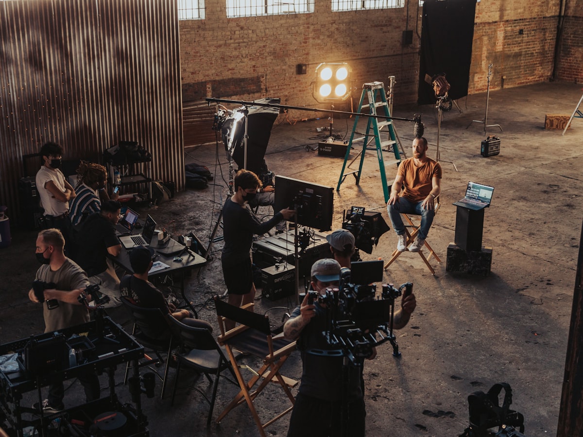 Video production crew setting up camera and lighting rig on a corporate shoot