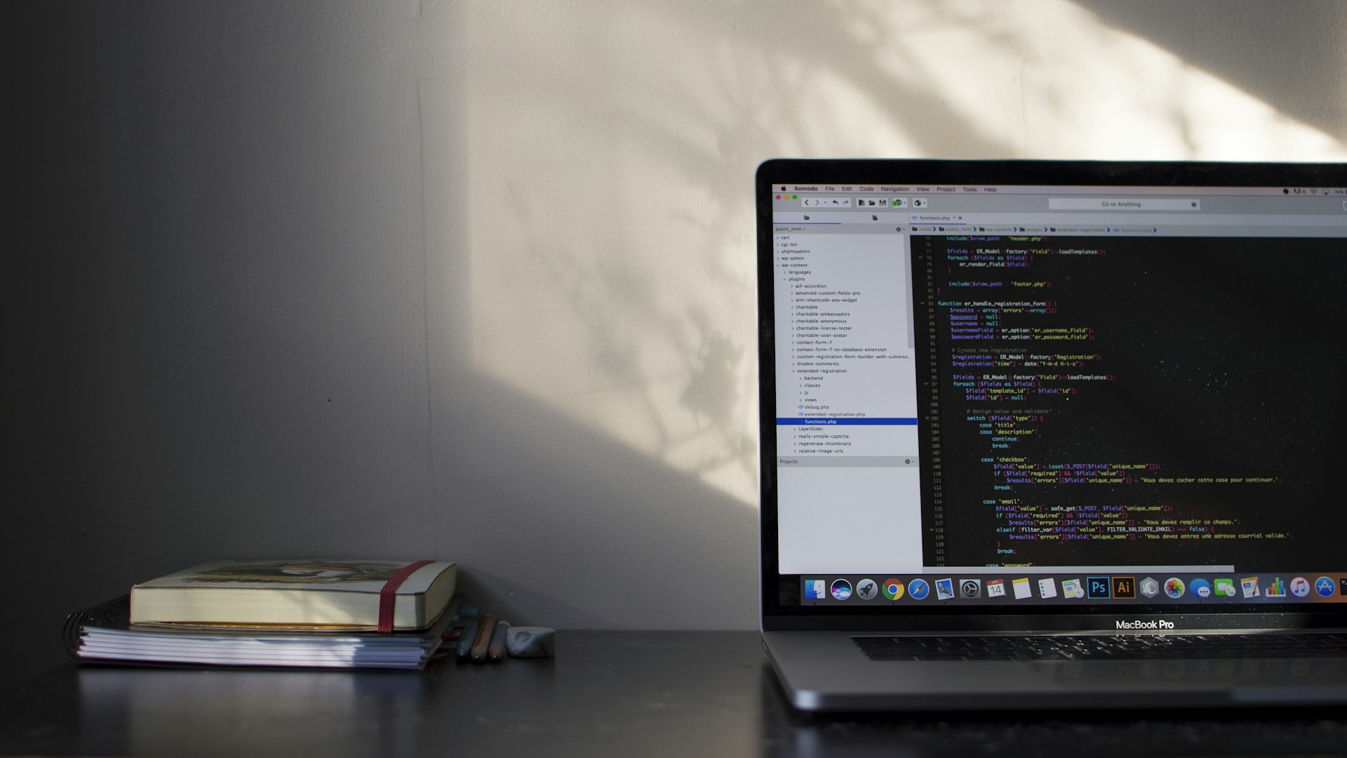 Laptop displaying code on a sunlit desk during website development